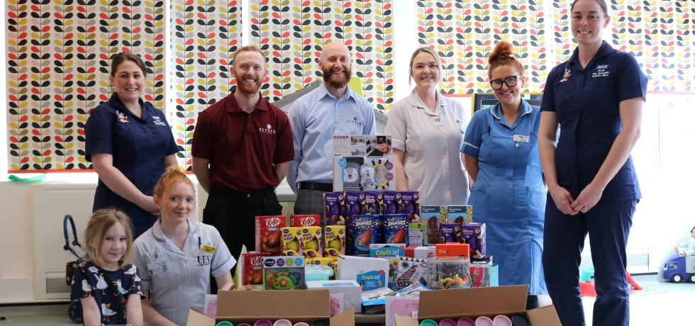 A picture of brothers Andrew and Jason Carson surrounded by nurses and a young child on Rudham Ward, delivering various toys and goods.